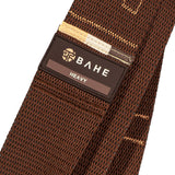 Brown tie with 'BAHE' label on a white background